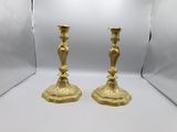 pair of antique brass candlesticks on a white background