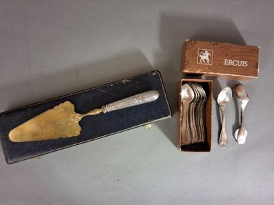 a box with silverware and a spoon and spoon rest in it