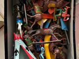 a box full of toy horses and a banana in it
