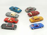 several toy cars are lined up in a row on a white surface