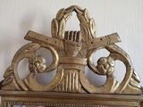 a gold clock with a basket on top of it