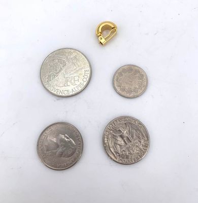 three coins and a quarter are sitting next to each other on a white surface