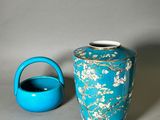 a blue vase and a teapot sitting next to each other
