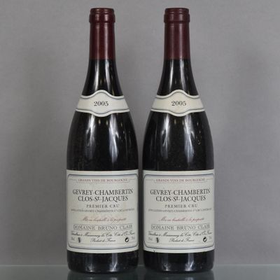 two bottles of wine sitting on top of a table next to each other