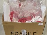 a cardboard box with a bunch of red and white string in it