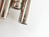 a pair of silver metal tubes on a white surface