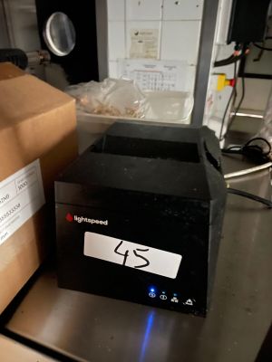 a black box sitting on top of a counter next to a box