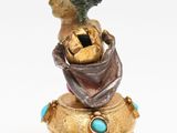 an image of a figurine of a woman sitting on top of a box