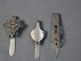 three silver spoons and a silver spoon with a bird on it