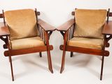 pair of mid - century danish lounge chairs with upholstered cushions