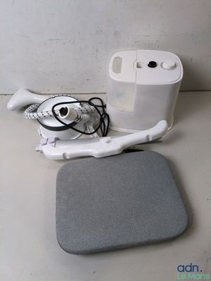 a white device and a gray cushion on a table