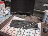 a desk with a keyboard, mouse and a monitor on it