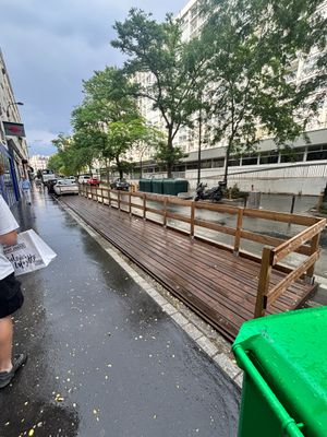 a man that is walking down the street in the rain