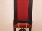 a red and black chair sitting on a wooden floor