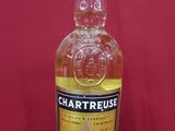 a close up of a bottle of whisky on a red surface