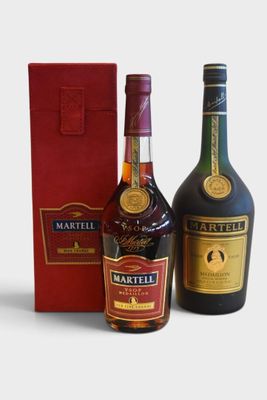 two bottles of wine and a red box on a white surface