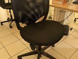 a black office chair in front of a computer monitor