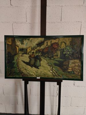 une photo d'un tableau posé sur un support devant un mur de briques