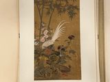 an open book with a picture of a bird and flowers on it