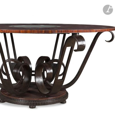 a close up of a table with a metal base and a wooden top