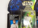 three star wars action figures sit on a white surface