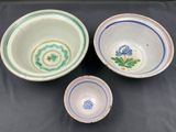 three bowls with designs on them are sitting on a table