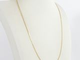 a white mannequin torso with a gold chain on it