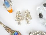 a lot of jewelry on a white surface