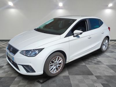 a white ford fiesta parked on a checkered tile floor