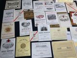 many different types of wine labels displayed on a table
