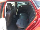 a red car with a black seat cover in the back of it