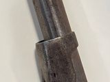 a metal pipe that is on a white surface