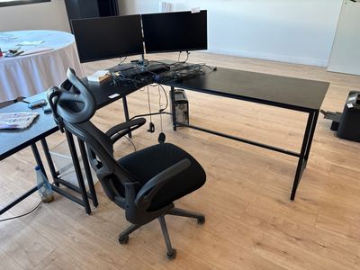 a desk with a chair and a computer monitor on it
