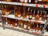 bottles of wine on a shelf in a store for sale