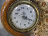 a close up of a clock on a table