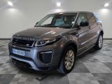 a picture of a grey land rover parked in a garage