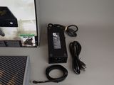 a box with a game controller and a charger on the table