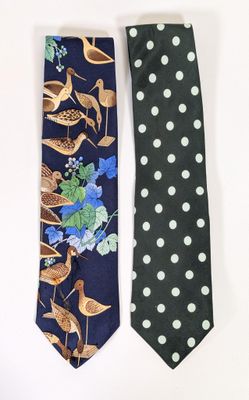 two neck ties with birds and flowers on them on a white background
