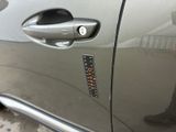 a close up of a car door handle with a sticker on it