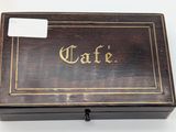 an old wooden box with writing on it sitting on a table