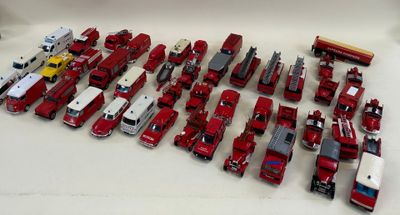a lot of red and white toy trucks on a table