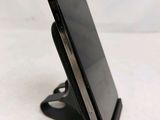 a cell phone that is sitting on top of a stand