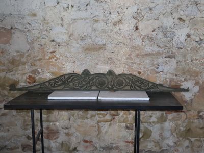 a small table with a book on it in front of a brick wall