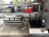 stainless steel counter top in a commercial kitchen with pots and pans on it