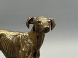 a statue of a dog that is standing on a table