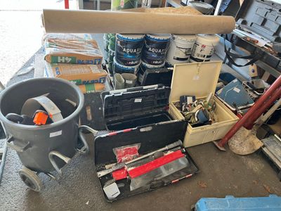 a pile of tools and tools sitting on the floor