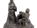 statue of a woman and two children in a boat with a man sitting on the boat