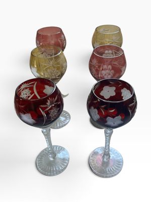 four wine glasses sitting next to each other on a table