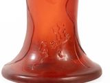 a red glass vase with a deer design on it