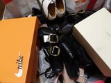 many pairs of shoes and a box on the floor